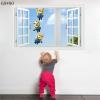 Samolepka Mimoni za oknem Velikost: 90 x 60 cm