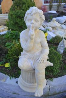 Chlapec sedící - kamenná socha z pískovce