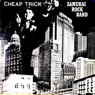 LP Cheap Trick ‎– Samurai Rock Band (White Label, Unofficial Release. Pravděpodobně živák Rockford IL v Rockford Amory říjen 1977. Na desce hodně vlásenek a jemných oděrek, zvuk ok. Obal obnošený a má roztržený horní hřbet.)