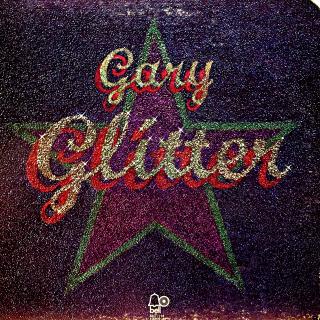 LP Gary Glitter – Glitter (Deska je mírně ohraná s pár vlásenkami a několika malými povrchovými oděrkami. Hraje fajn, velmi dobrý zvuk, jen pár otoček jsou slyšet mírné prskance. Rozevírací obal je mírně obnošený s proseknutou jednou hranou.)