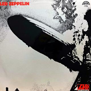 LP Led Zeppelin ‎– Led Zeppelin (Deska je v pěkném stavu, jen lehce ohraná s jemnými vlásenkami a jednou drobnou povrchovou oděrkou. Hraje fajn, bezvadný zvuk, jen mírný praskot v pasážích mezi skladbami. Obal je lesklý a v krásném stavu.)