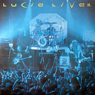 LP Lucie ‎– Live II (Včetně přílohy s barevnými fotkami. Deska v pěkném stavu, pouze lehce ohraná s jemnými vlásenkami a drobnými povrchovými oděrkami. Hraje fajn, čistý zvuk. Obal v perfektní kondici.)