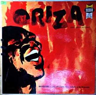 LP Silvestre Mendez Y Su Orquesta ‎– Oriza (Afro-Cuban Rhythms) (Deska je ohraná s vlásenkami i oděrkami. Nicméně hraje fajn, pouze mírný praskot v záznamu. Obal v horším stavu. Má do půlky roztrženou horní i spodní hranu. Potisk je z obou stran ok.)