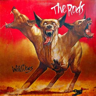 LP The Rods ‎– Wild Dogs (Deska je mírně ohraná, jemné vlásenky a velmi jemné drobné kosmetické oděrky. Hraje velmi dobře s mírným praskotem v tichých pasážích. Obal je pěkný, jen lehce obnošený.)