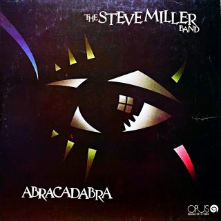 LP The Steve Miller Band ‎– Abracadabra (Deska je hodně ohraná, mnoho vlásenek i povrchových oděrek. Nicméně hraje stále dobře s mírným praskotem v záznamu. Obal jen lehce obnošený.)