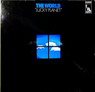 LP The World ‎– Lucky Planet (Deska lehce ohraná, jemné vlásenky a povrchové oděrky. Hraje fajn, pouze mírný praskot v tichých pasážích. Rozevírací obal v pěkném stavu.)