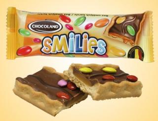 Chcoland SMILIES 27 g s lentilkami - karamelová - DMT 01.12.2023 (Křupavá sušenka s karamelovým krémem (26 %), s belgickou mléčnou čokoládou (18 %) a dražé v cukrové polevě (5 %).)