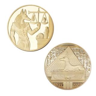 Kovová mince s egyptskými symboly